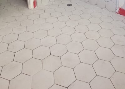 Hexagon tile installation on the shower floor, highlighting the clean geometric design and tile placement.