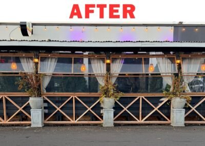 Professional installation of new wooden panels with structural 'X' design to reinforce and beautify the restaurant/business patio enclosure.